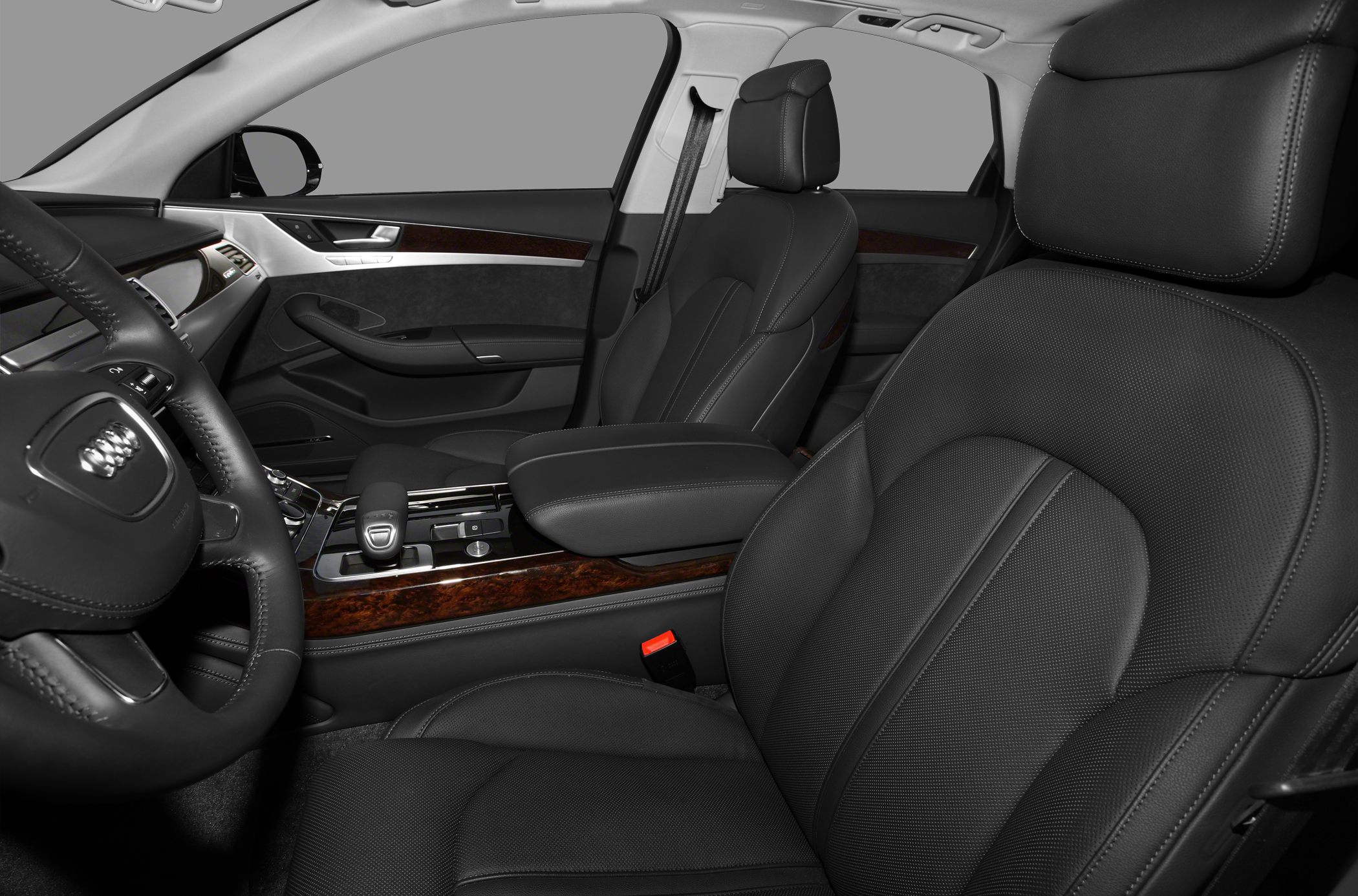 Luxury car interior with leather seats, wood trim, and central console.
