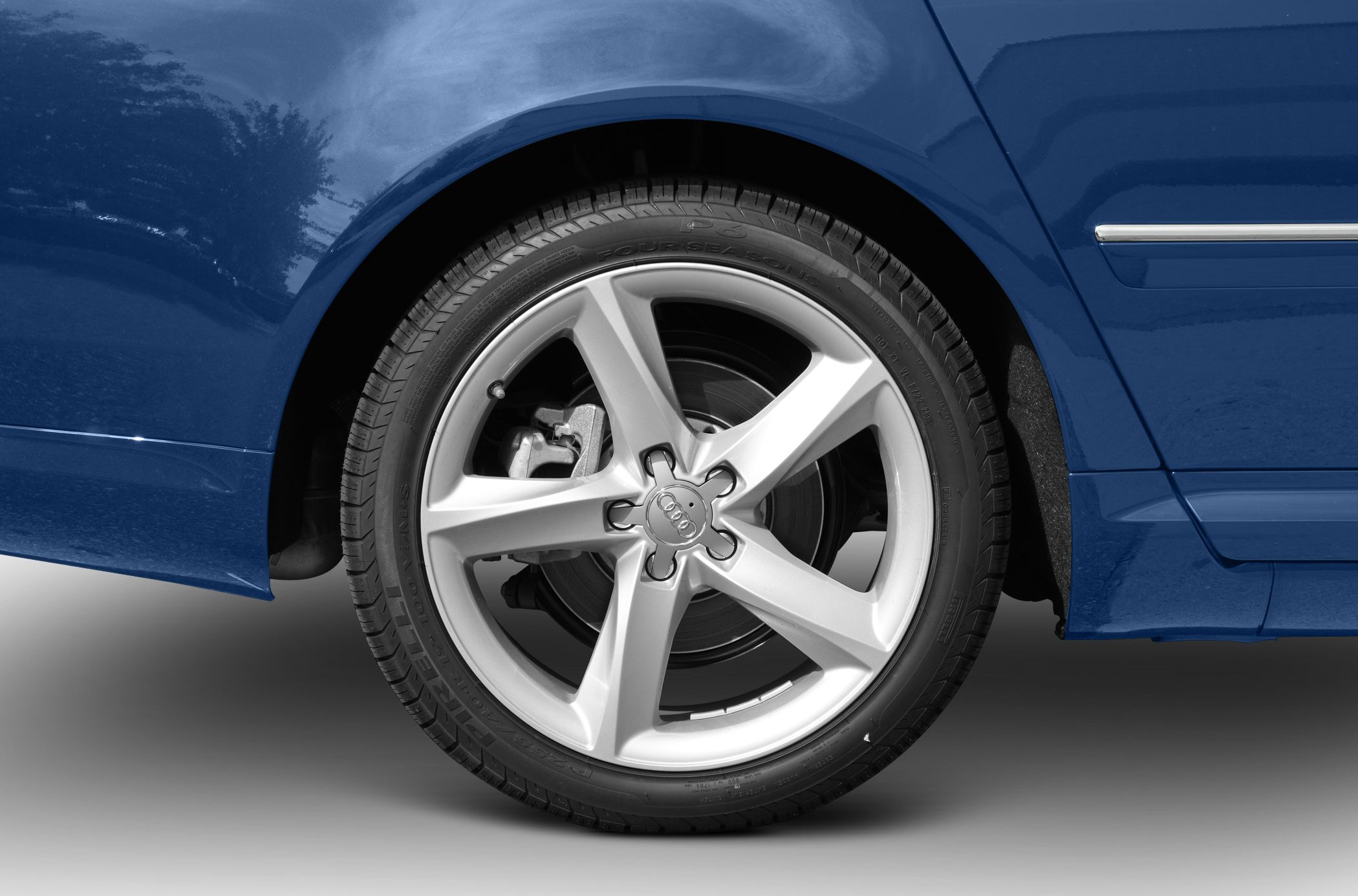 Close-up of an Audi alloy wheel and tire with visible brake caliper.