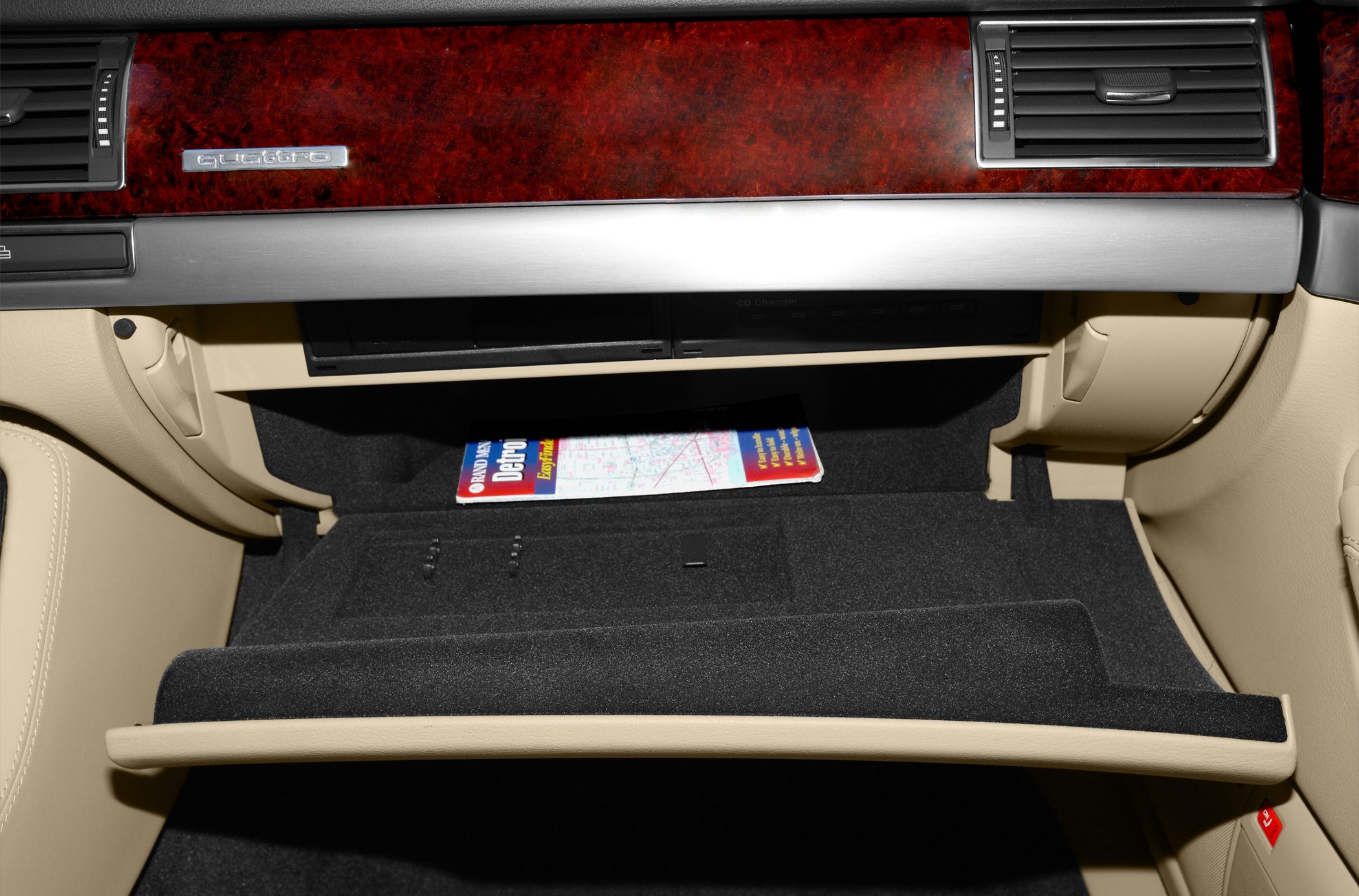 Open glove box with wood trim and quattro badge