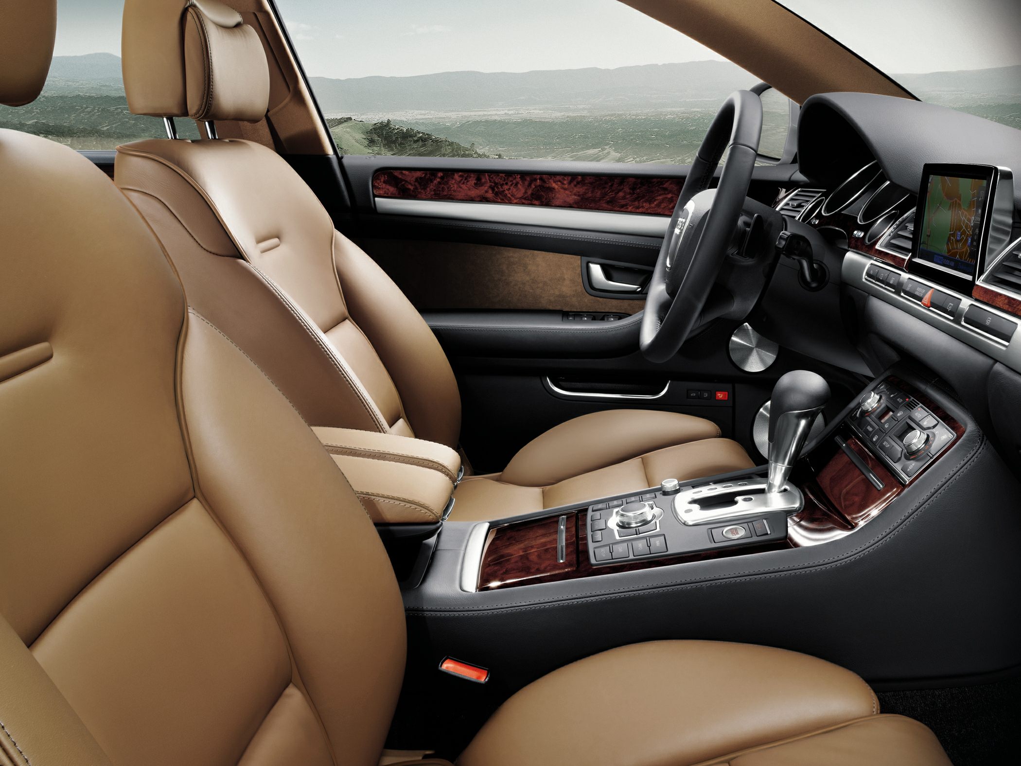 Tan leather seats with wood trim dashboard and central console controls.