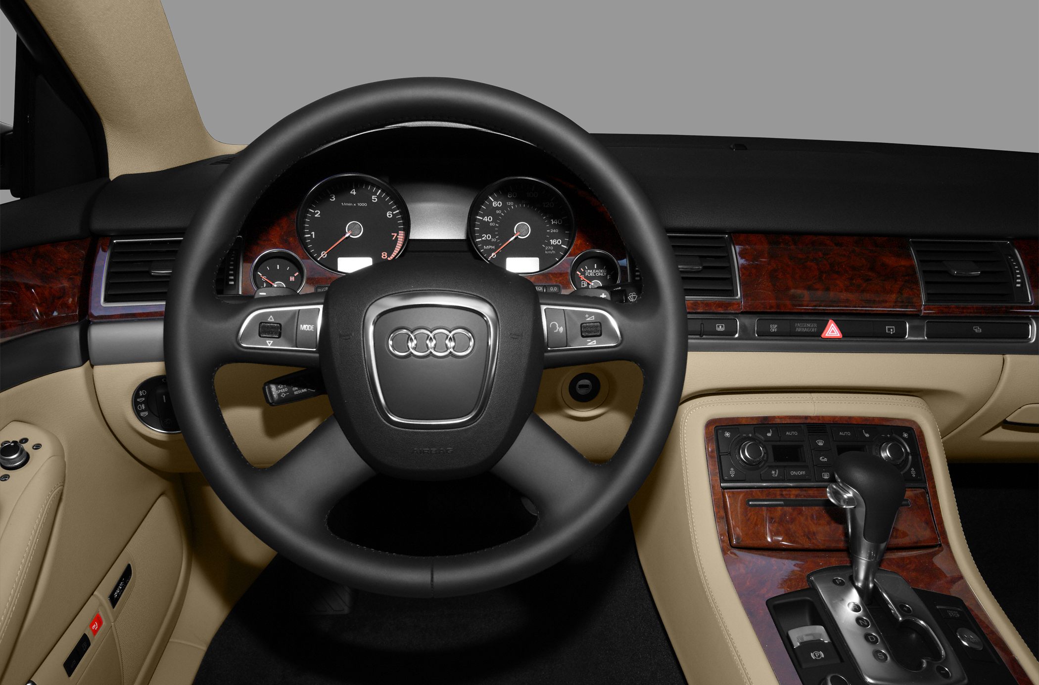 Dashboard and steering wheel with wood trim and beige interior