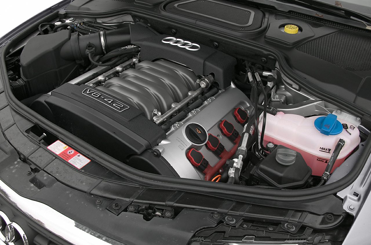 4.2L V8 engine in car engine bay with fluid reservoirs and wiring