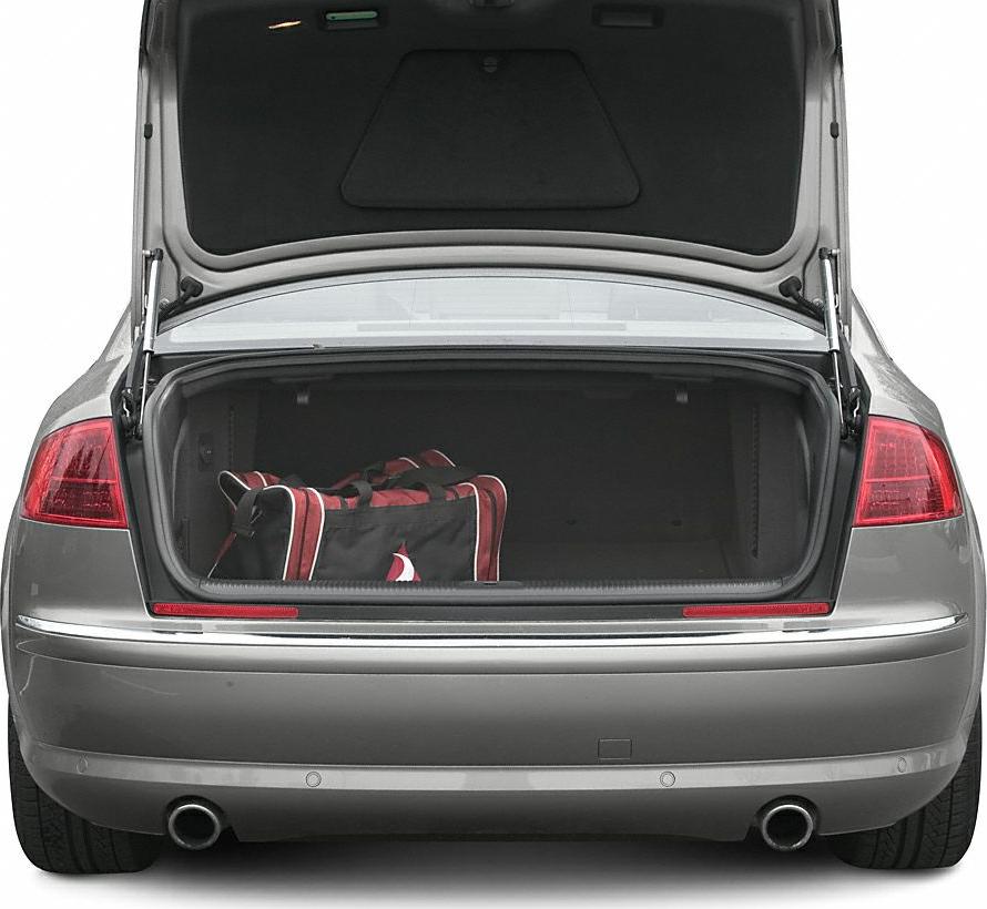 Open trunk with bag, dual exhaust pipes, and visible taillights