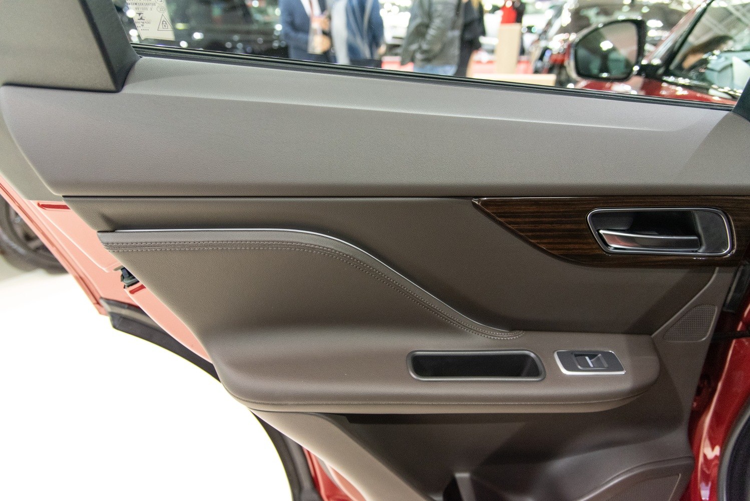 Interior door panel with leather trim and wood accent