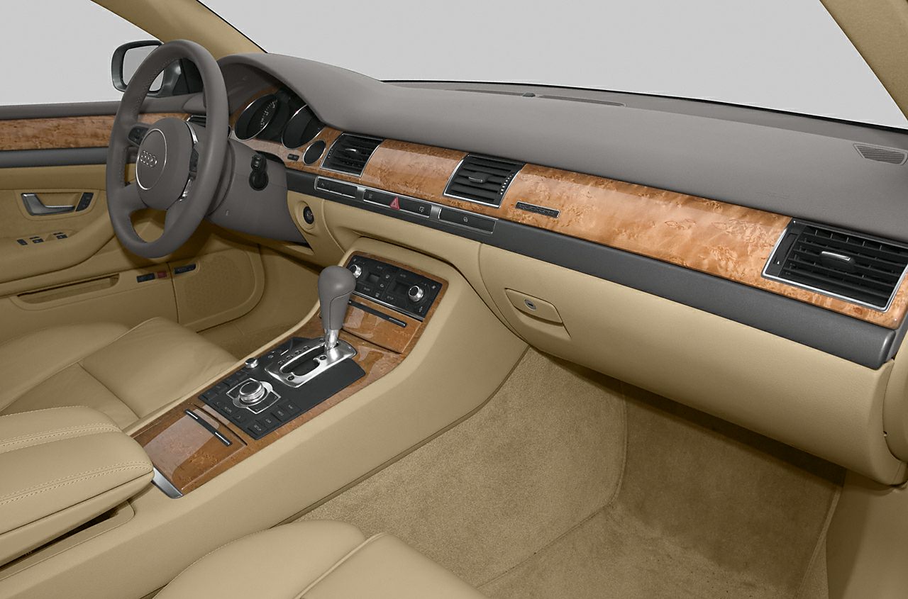 Beige leather seats and wooden dashboard trim with central gearshift and controls
