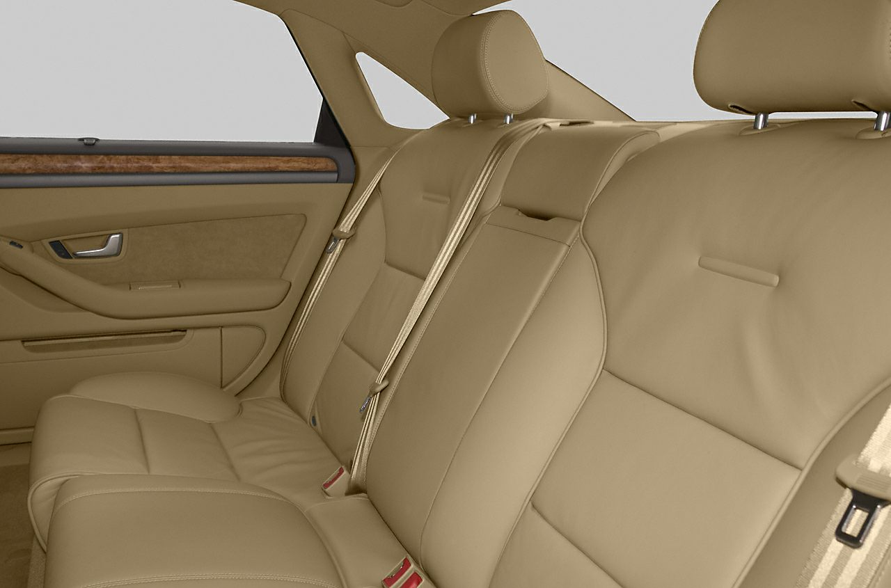 Beige leather rear seats with headrests and wooden trim