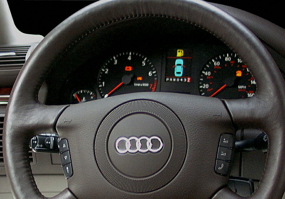 Audi-style instrument cluster with tachometer, speedometer, digital display and leather steering wheel controls
