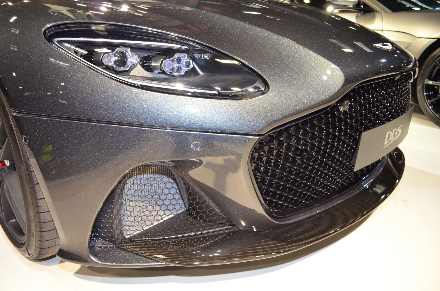 Front grille and headlight close-up with carbon fiber splitter
