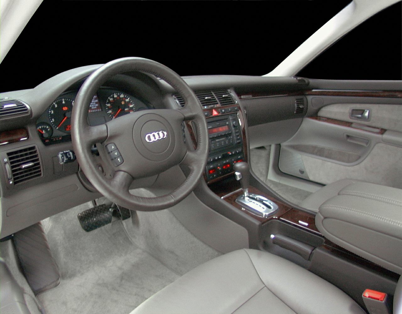 Car interior with steering wheel, dashboard, and automatic gear shifter