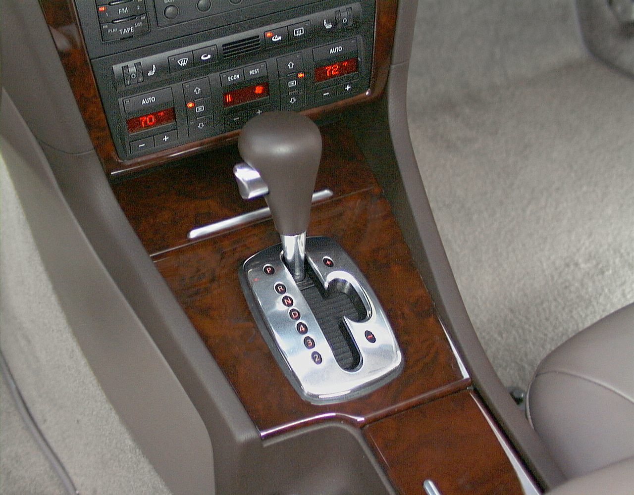 Automatic gear shifter and digital climate control panel in wood trim
