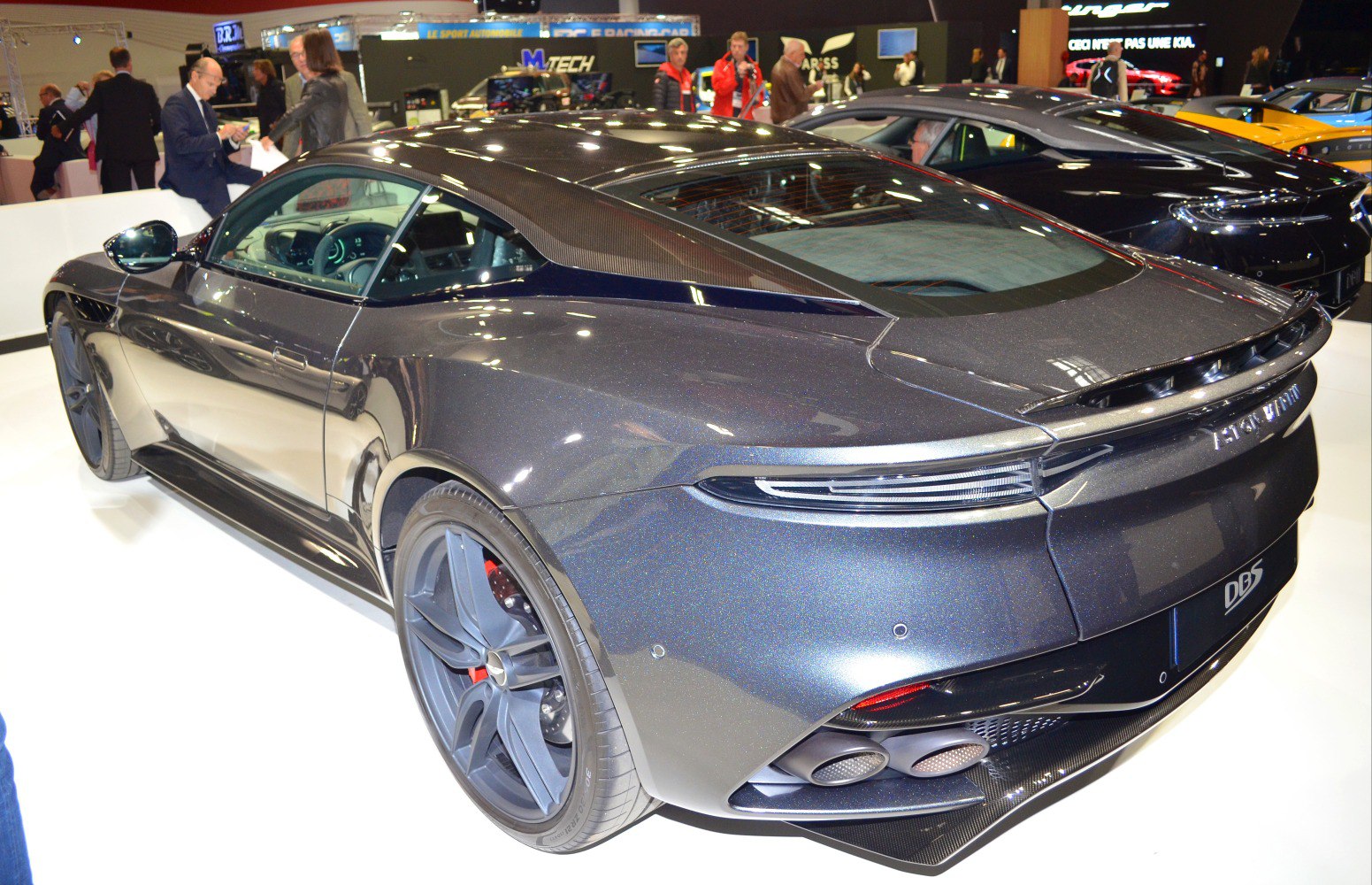 Rear view of sleek sports coupe with quad exhaust and carbon fiber roof