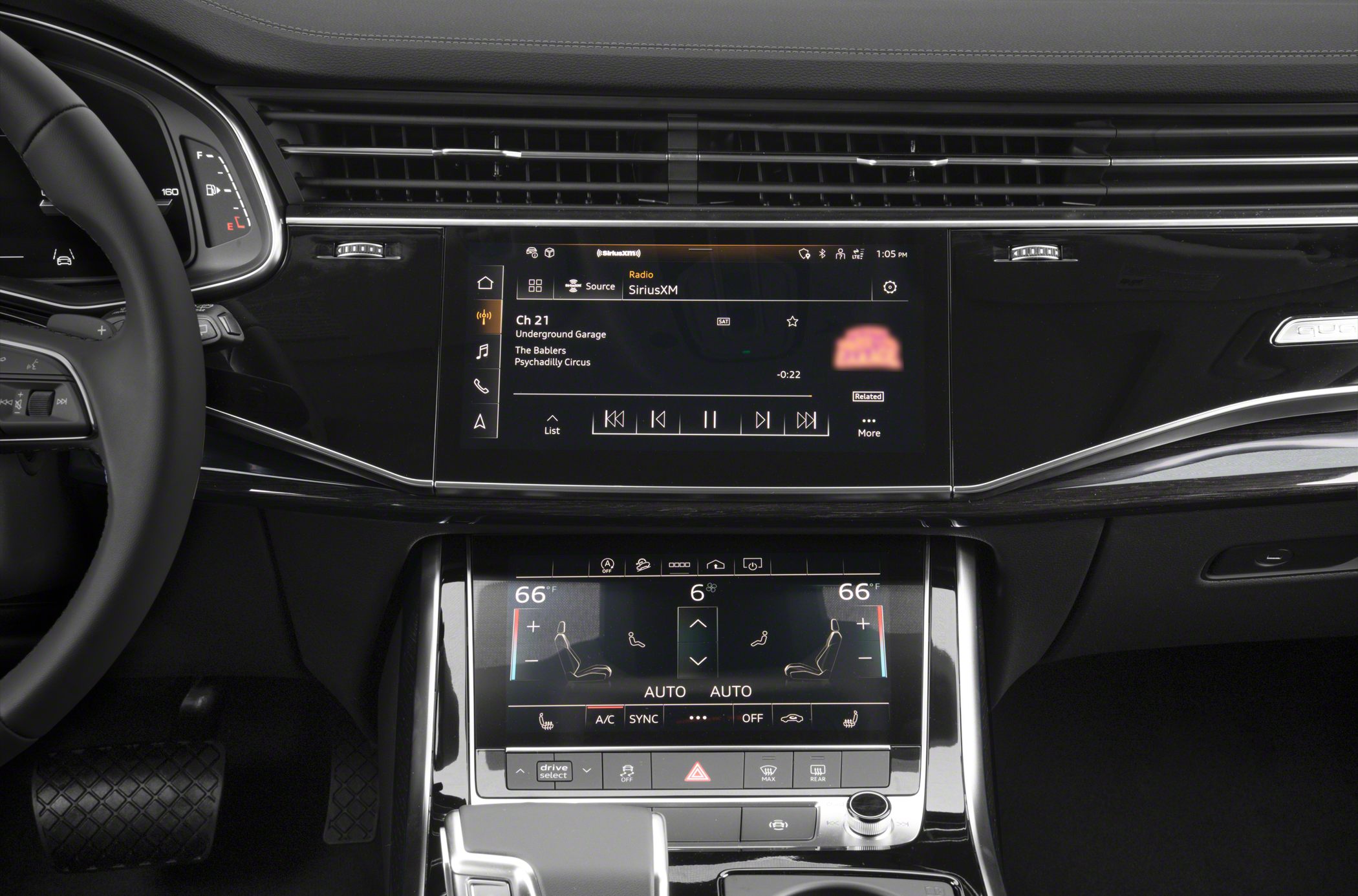 Dual touchscreen infotainment and climate control system with digital displays and control buttons