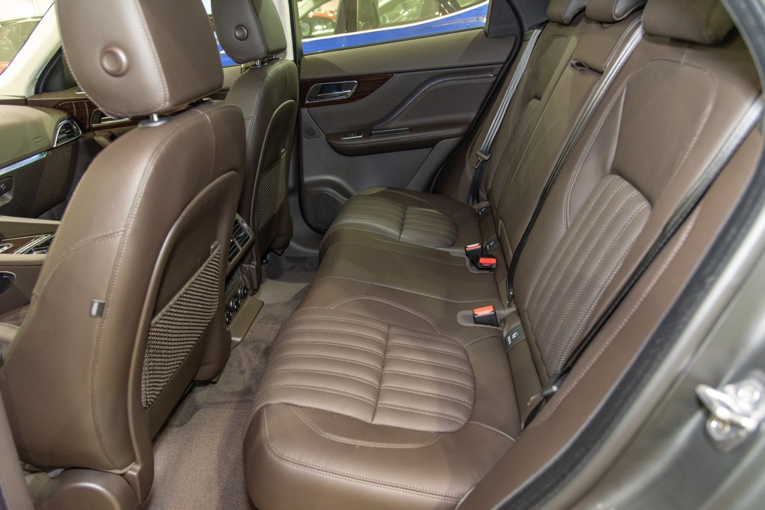 Brown leather rear seats with detailed stitching and spacious legroom
