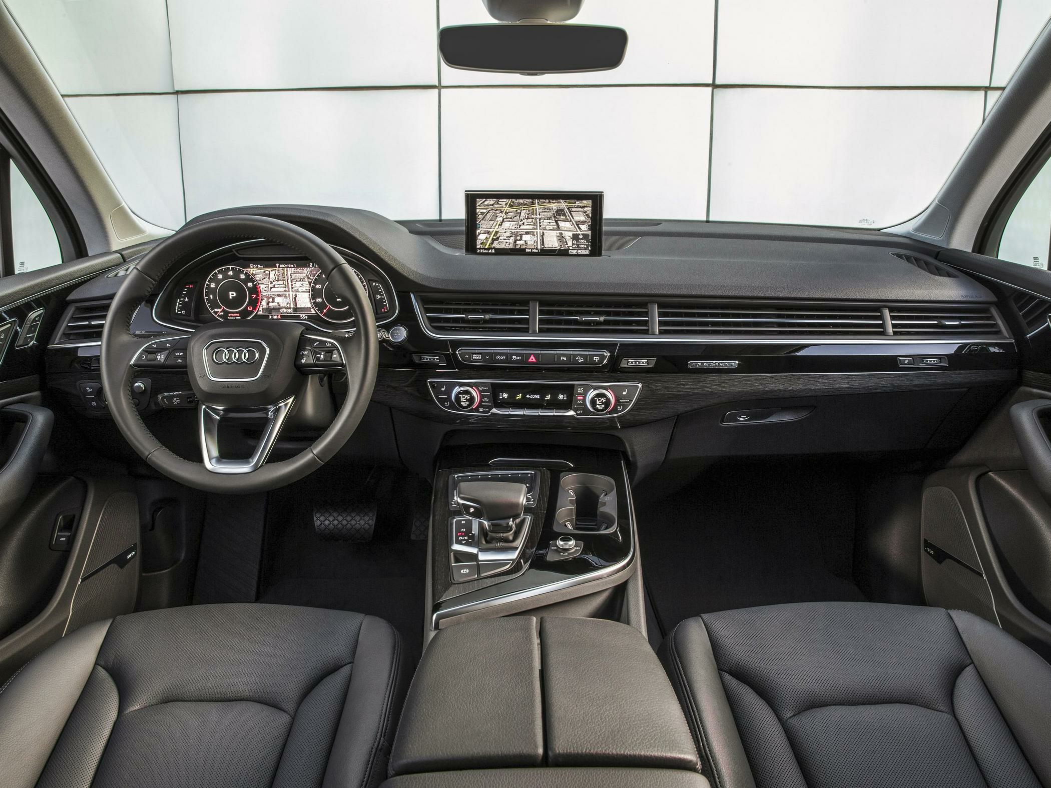 Digital dashboard, infotainment screen, center console with gear selector