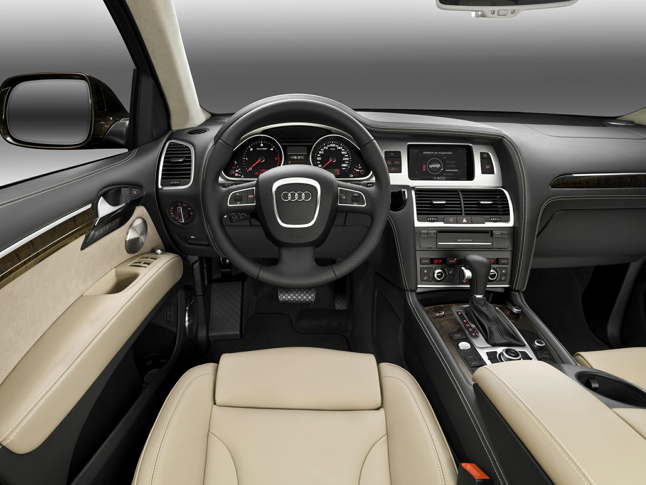 Beige leather seats with dashboard, steering wheel and center console controls