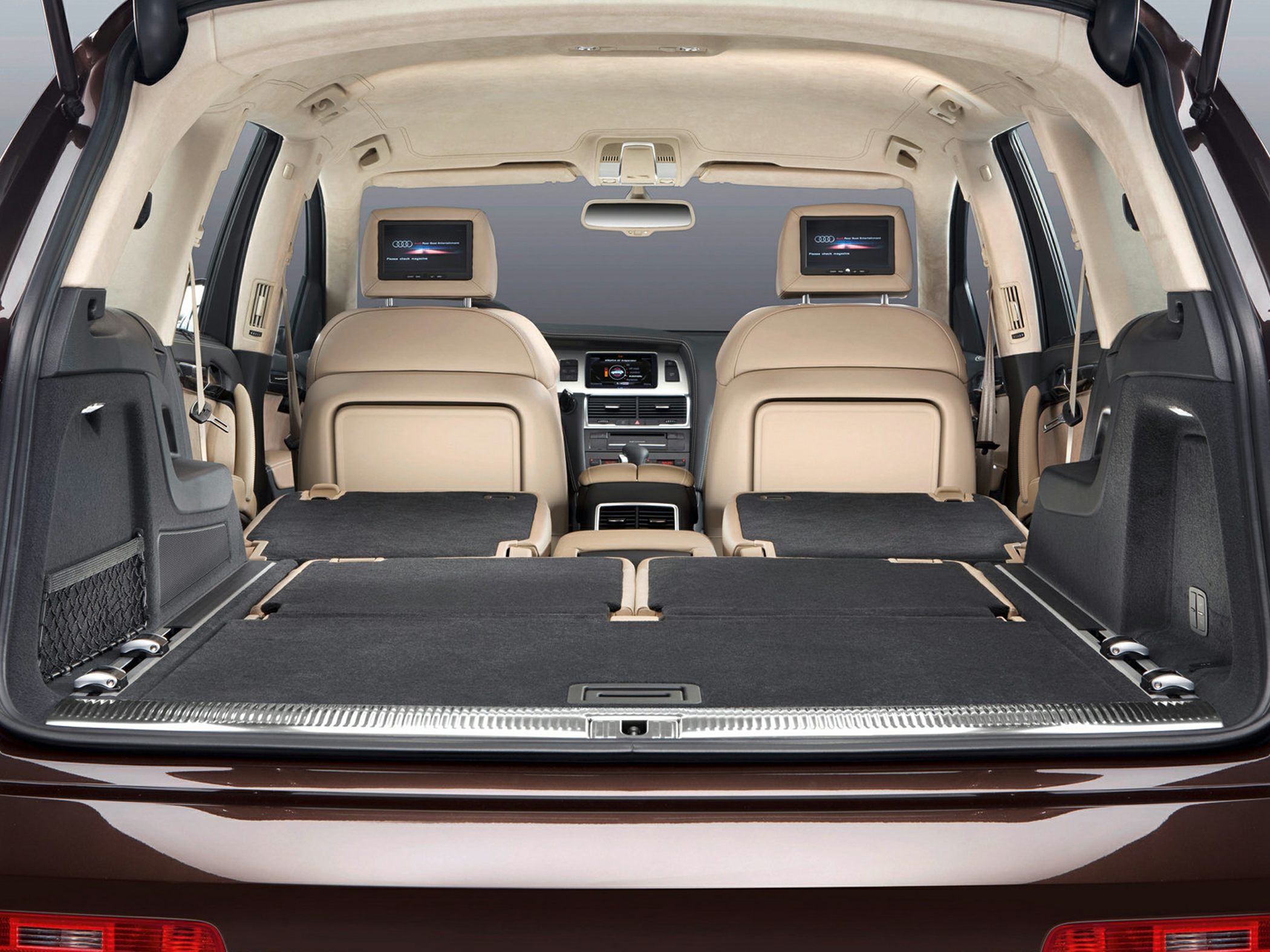 Folded rear seats and dual rear seat entertainment screens in SUV interior