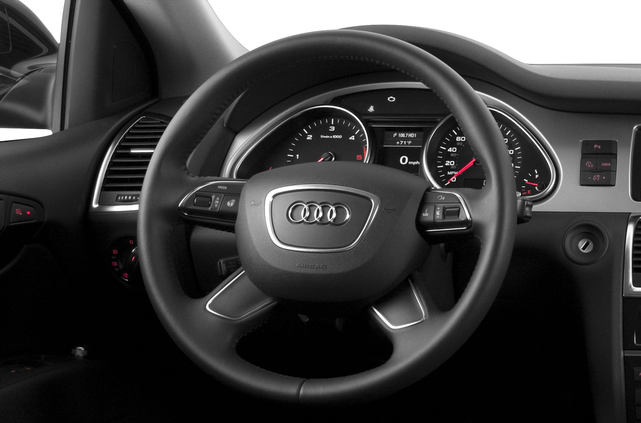 Steering wheel with controls and instrument cluster with speedometer and tachometer