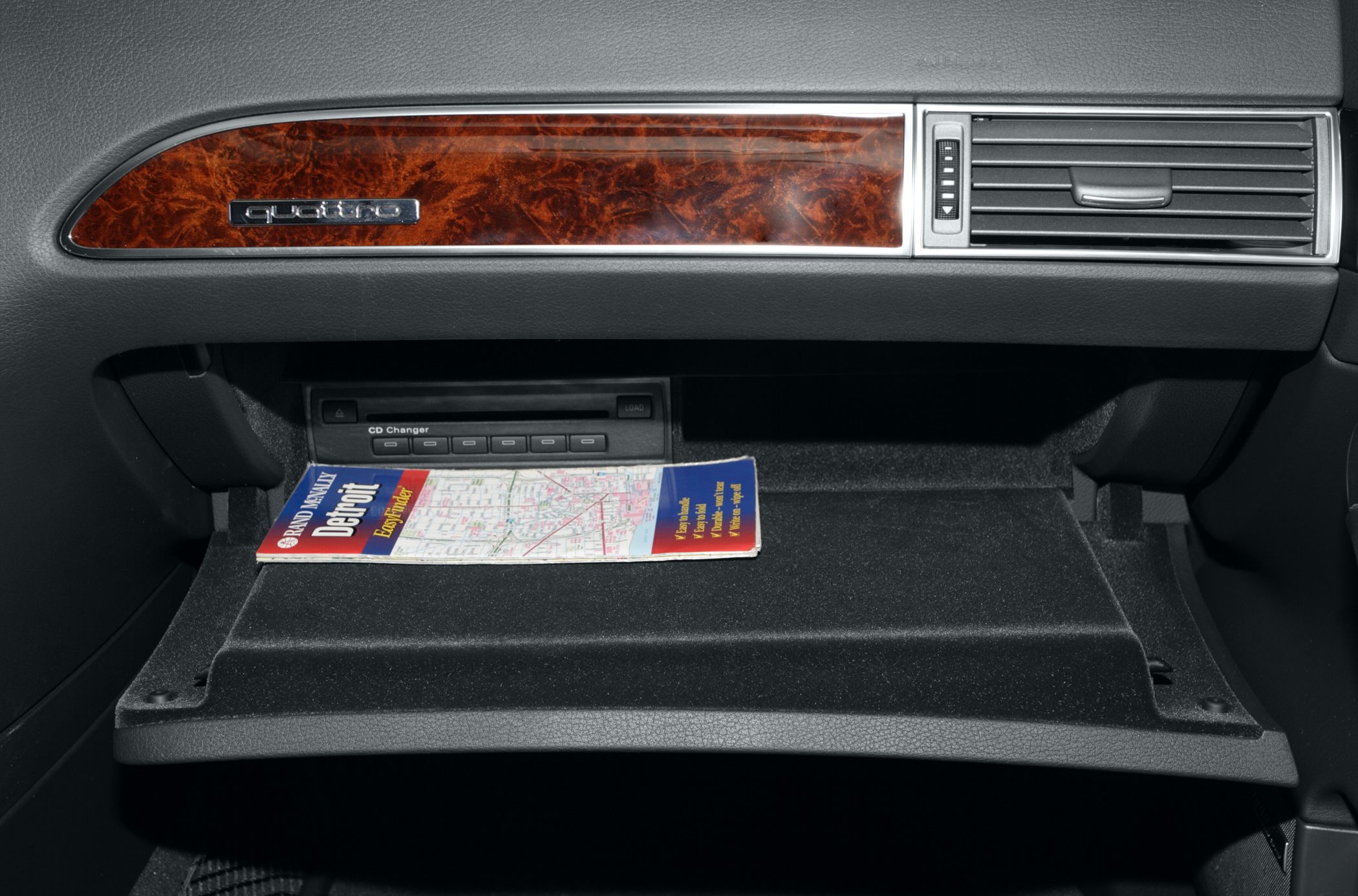 Glove compartment with CD changer and wood trim panel