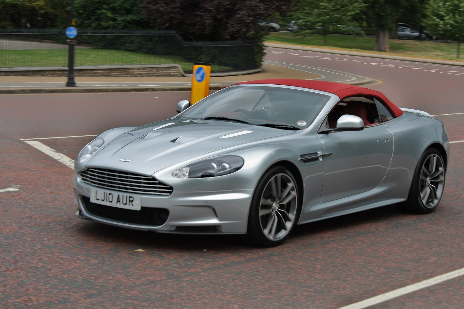 Convertible silver sports coupe with red soft top and sporty wheels