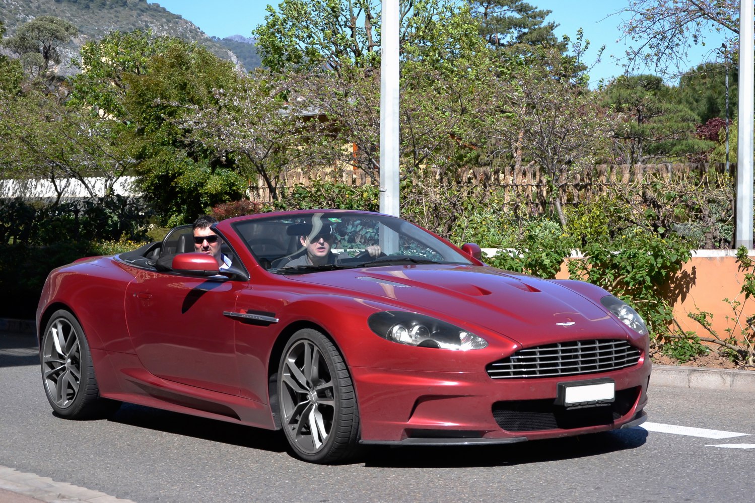 Red convertible with V12 engine and sleek front grille