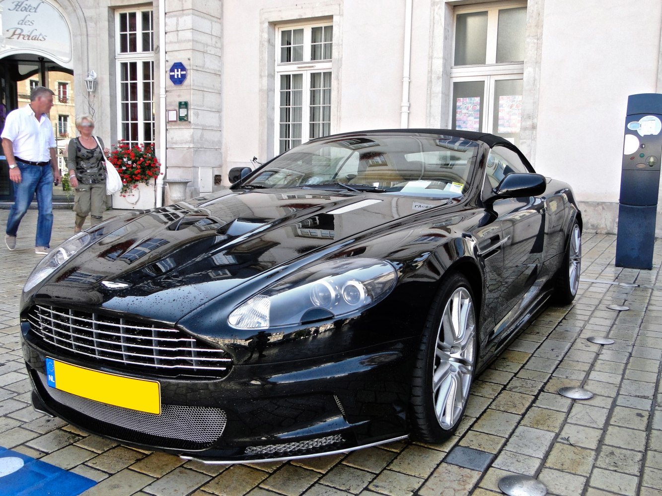Front and side view of convertible luxury sports car with distinctive grille and headlights