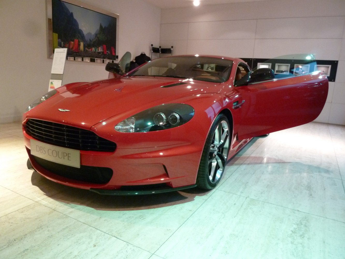 Front view of red sports coupe with open driver's door