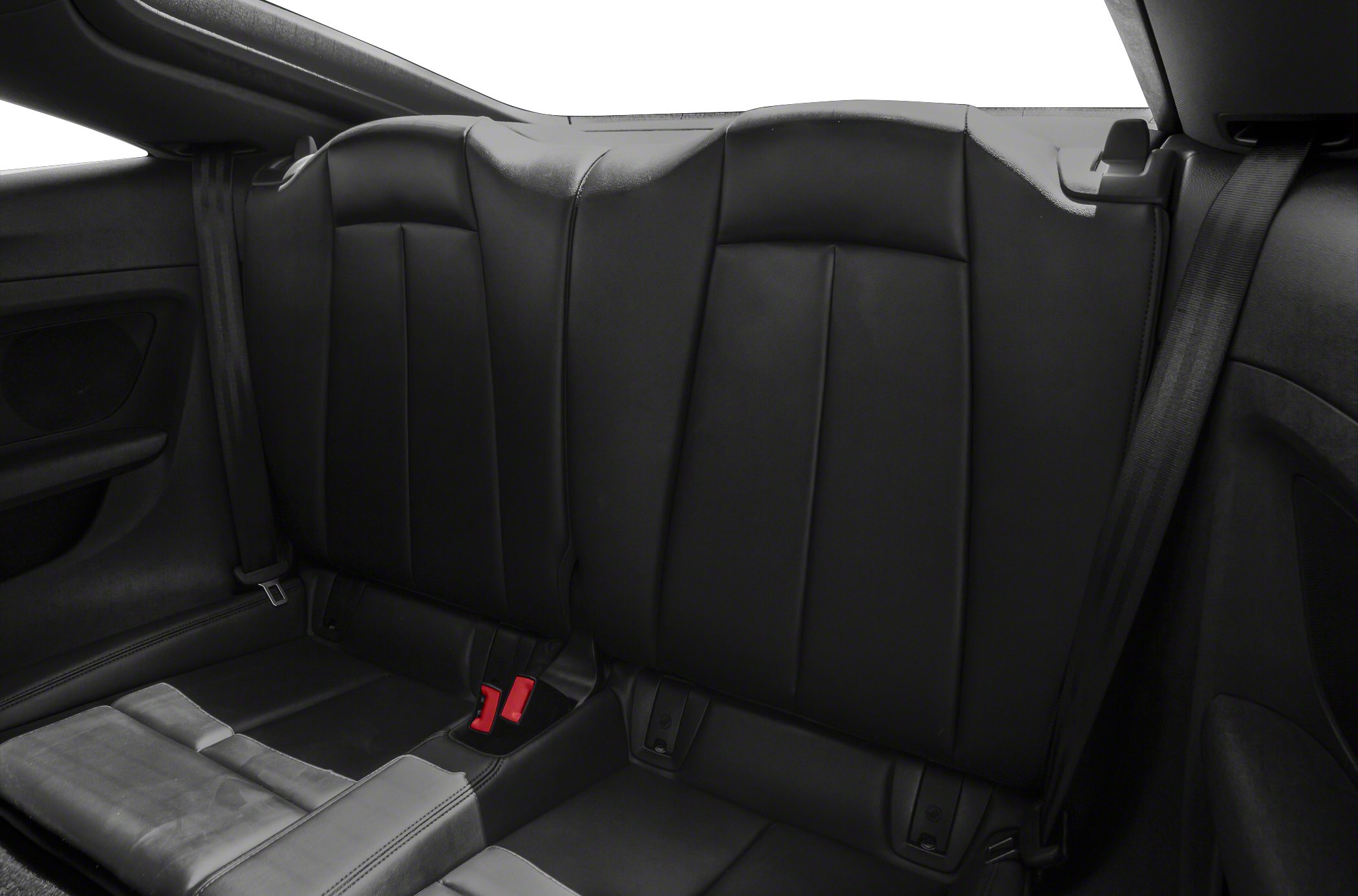 Black leather rear seats with integrated headrests and red seatbelt buckles.