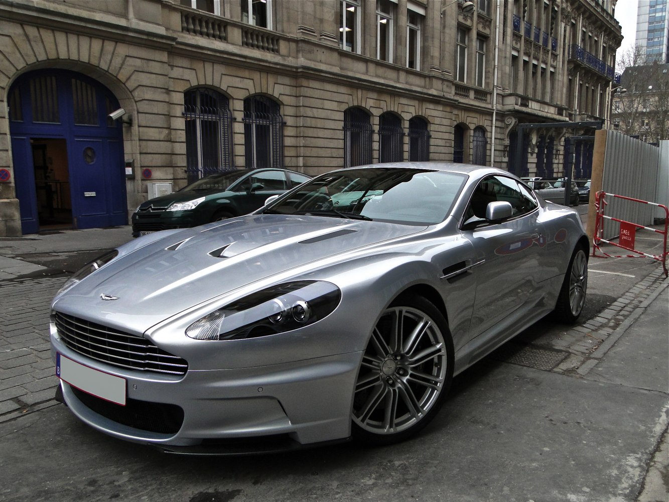Silver sports coupe with aerodynamic front grille and multi-spoke alloy wheels