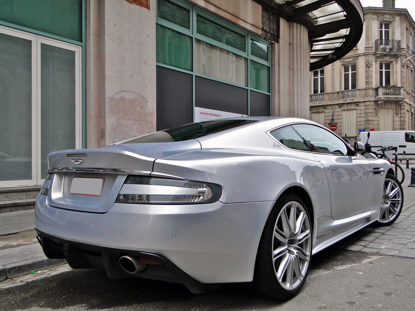 Sporty rear and sleek side profile of a silver luxury sports coupe.