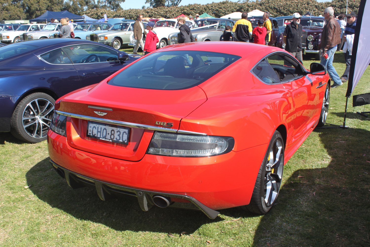 Red luxury coupe rear with dual exhausts and sleek sporty design.