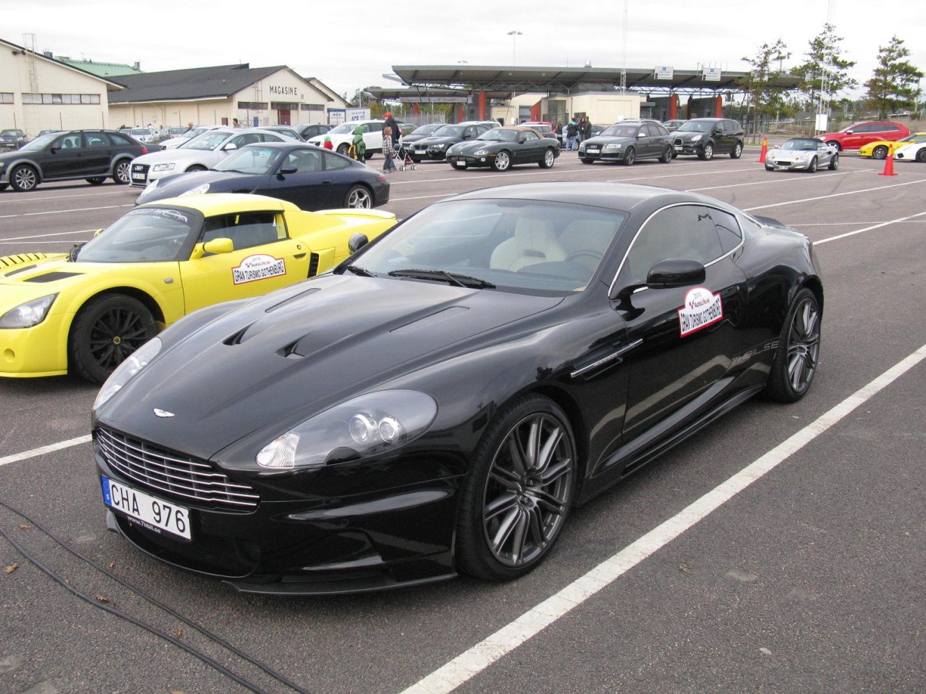 Black luxury sports car with vents and alloy wheels.