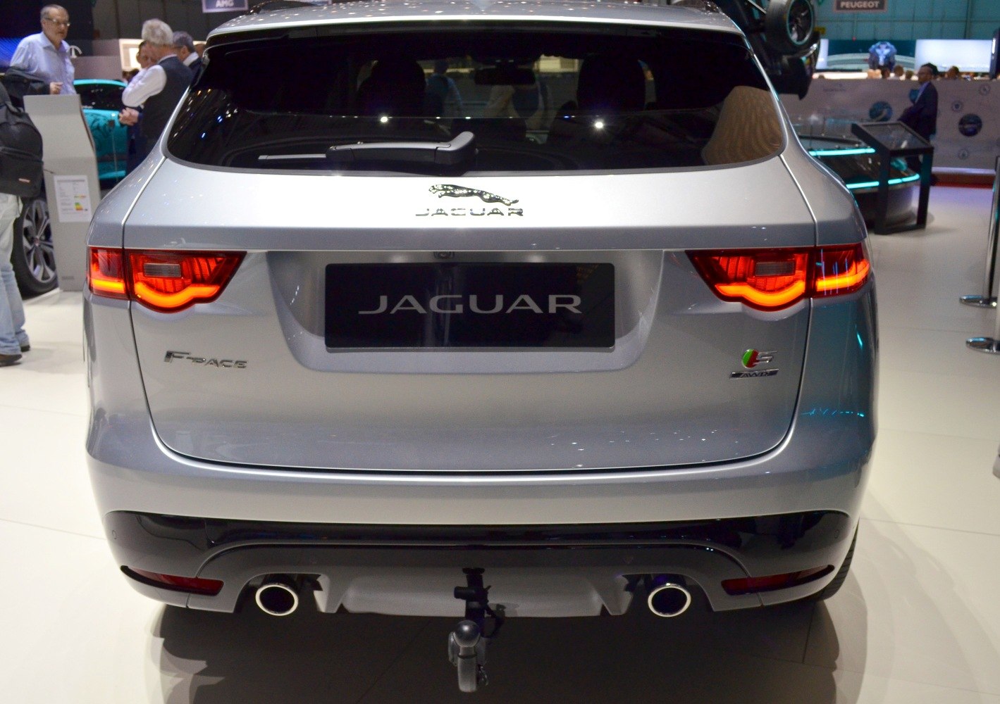 Rear view with illuminated tail lights and dual exhaust pipes
