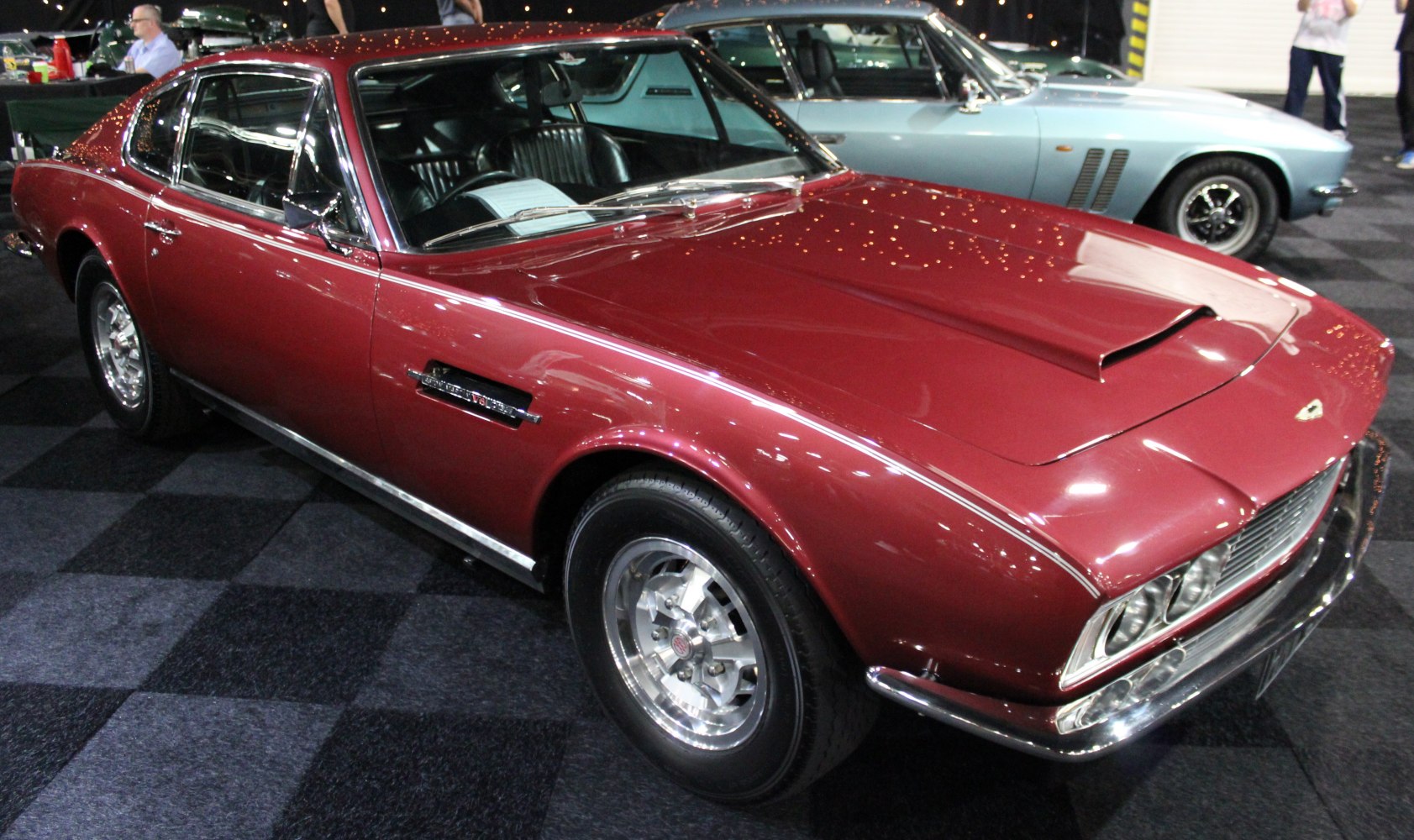 Muscle car front side with vented hood and chrome wheels