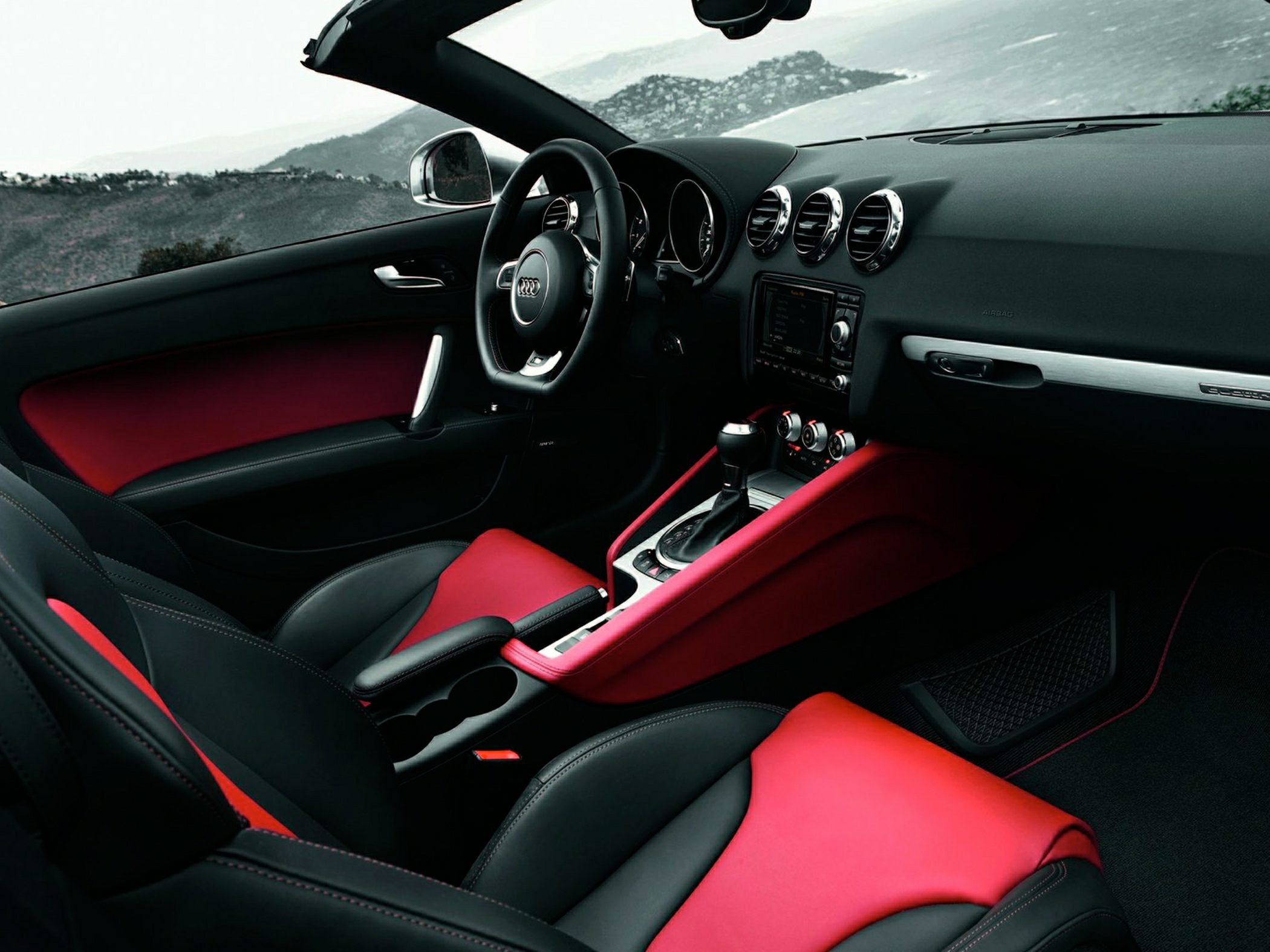 Sporty red and black interior with detailed dashboard and seats