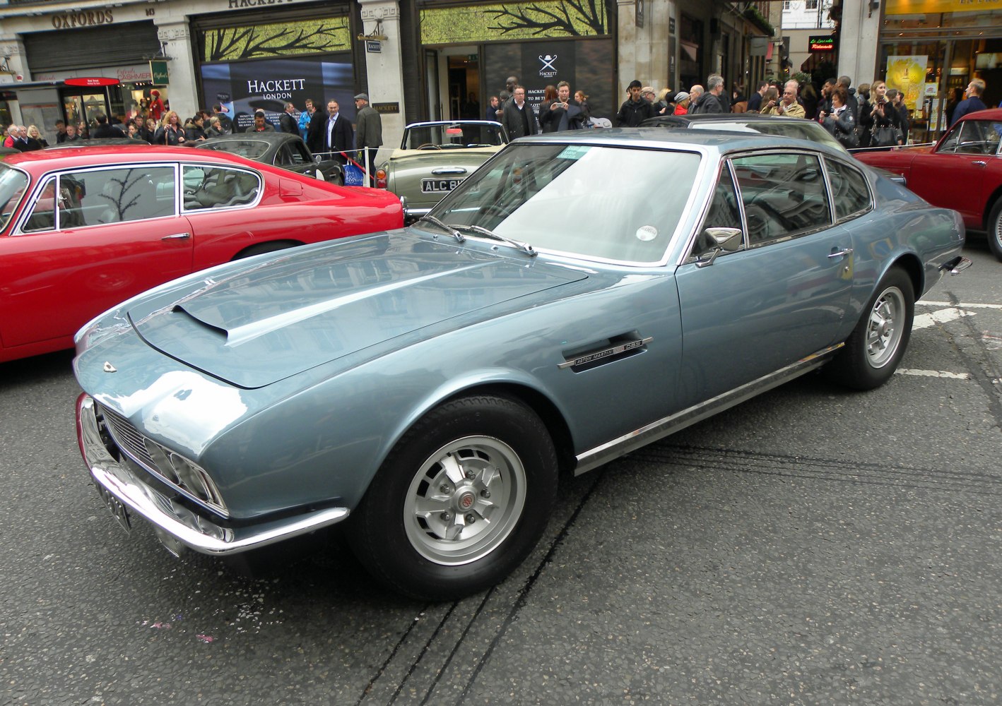 Classic car front and side profile with hood scoop and chrome wheel rims