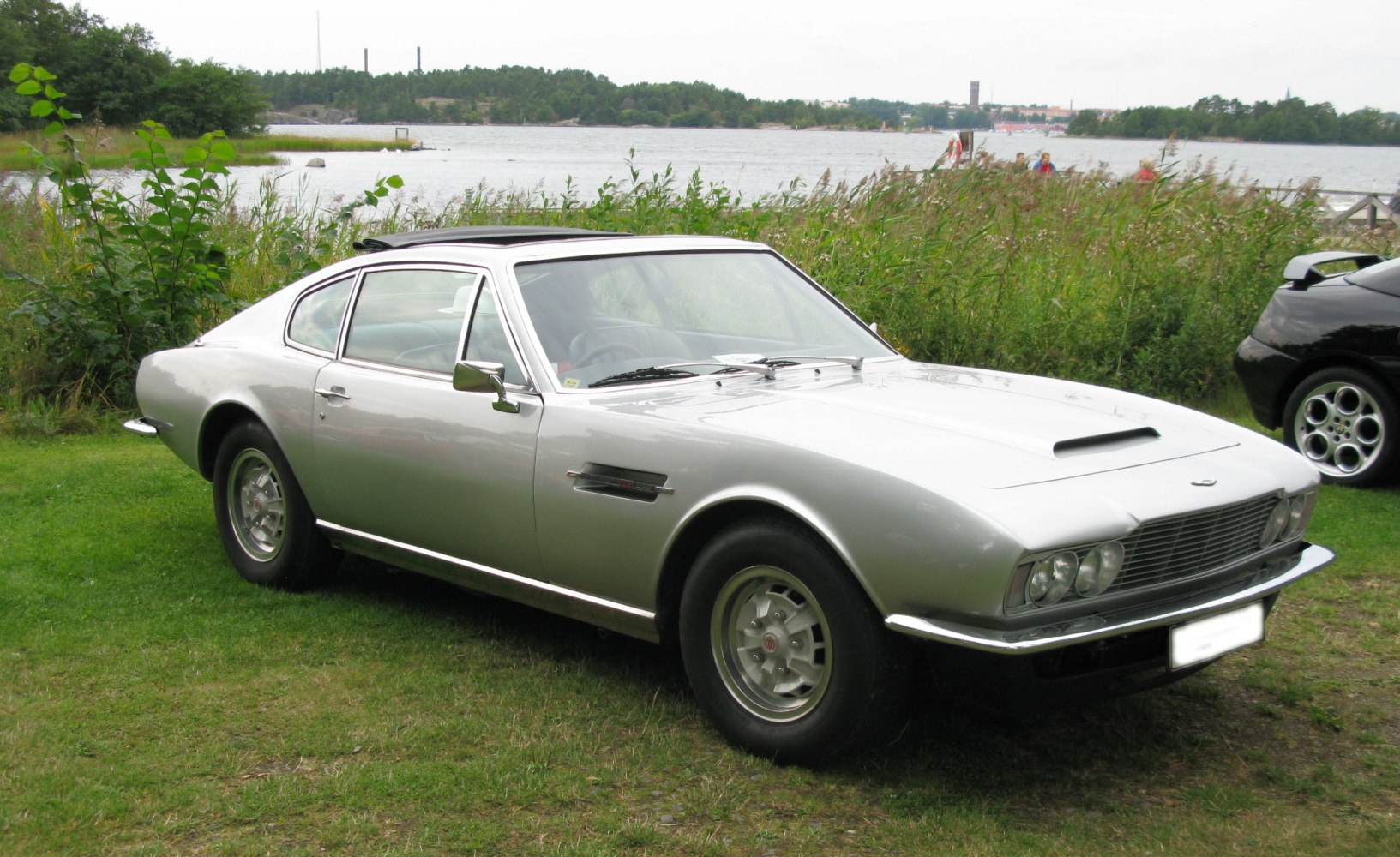 Two-door coupe with hood scoop and quad headlights