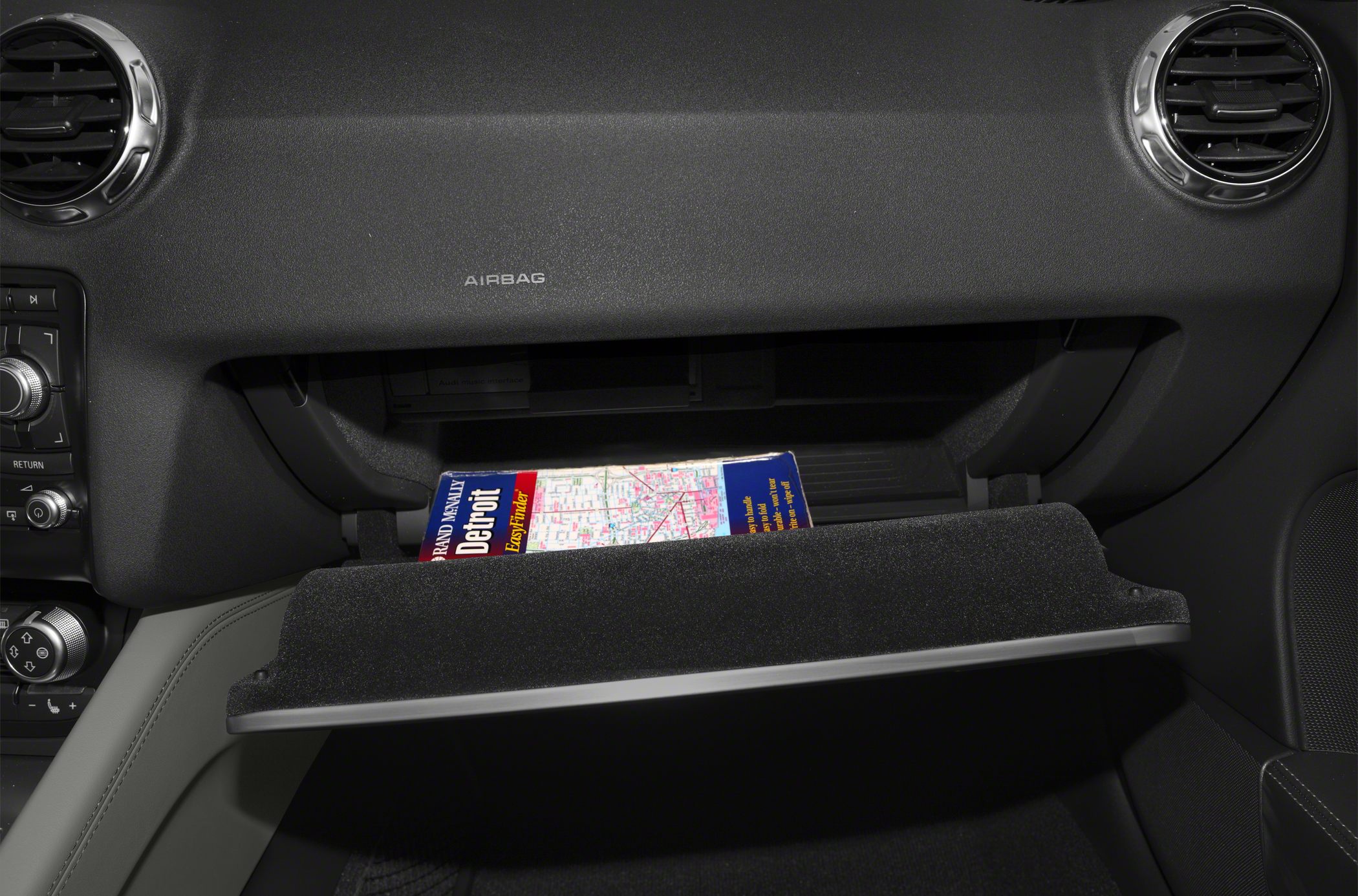 Open glove compartment with a Detroit map inside