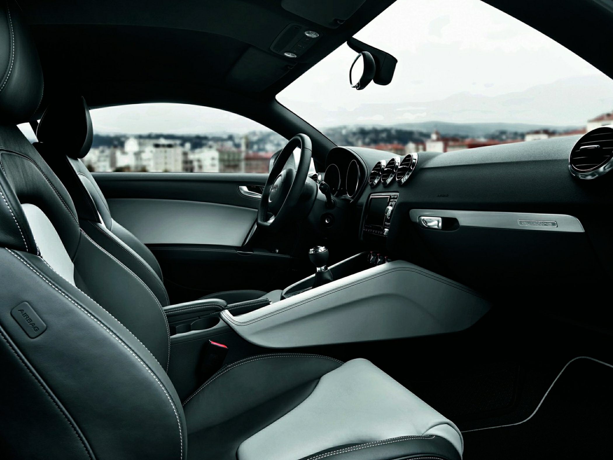 Leather seats and modern dashboard with round air vents