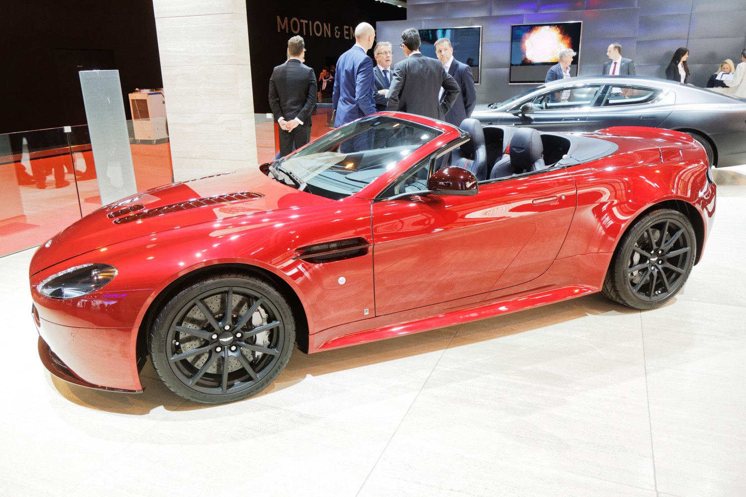 Red convertible sports car with black wheels and sleek design