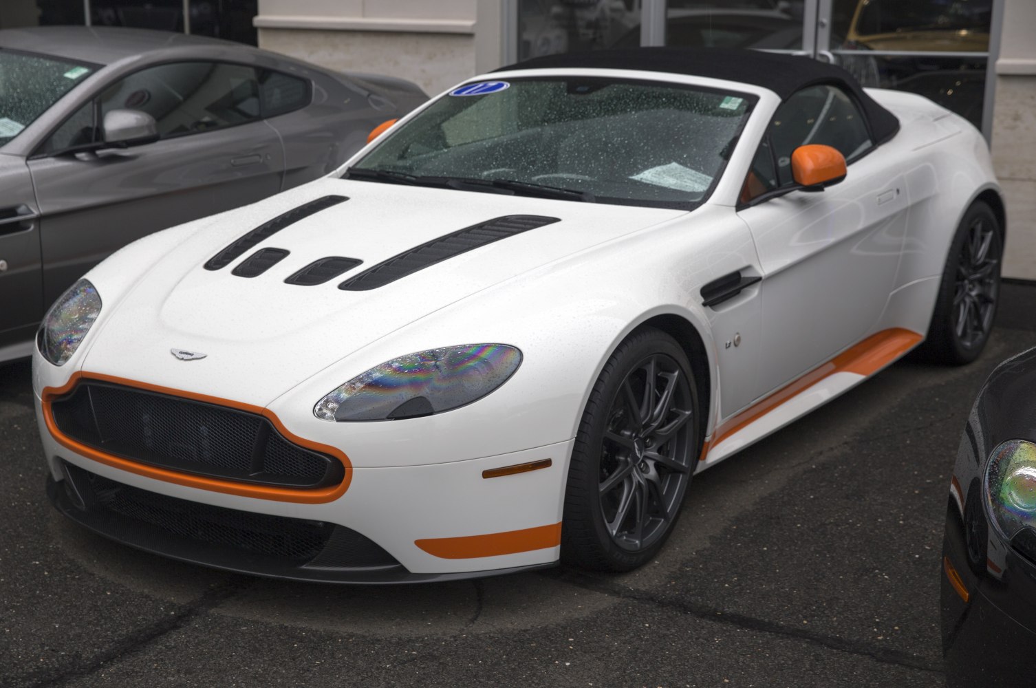 White convertible with black vented hood and orange accents