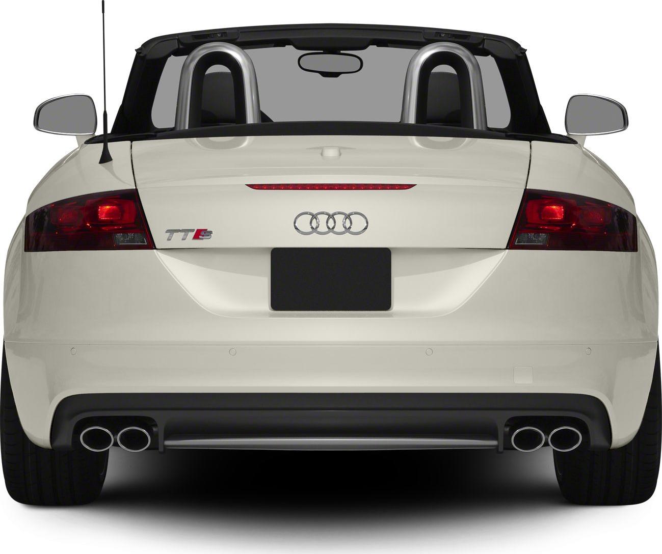Rear view of a convertible with quad exhaust tips and roll bars.