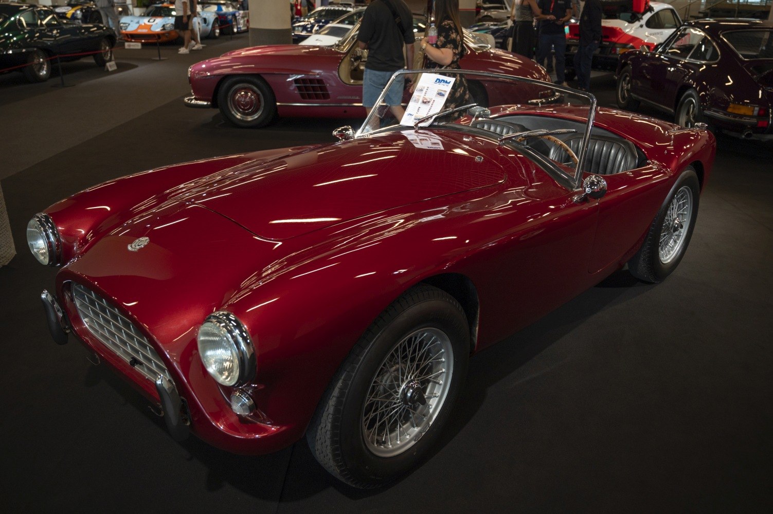 Open-top vintage sports roadster with wire spoke wheels and sleek curved body