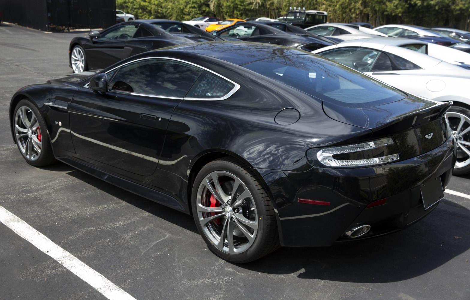 Black sports coupe rear side with alloy wheels and tail lights