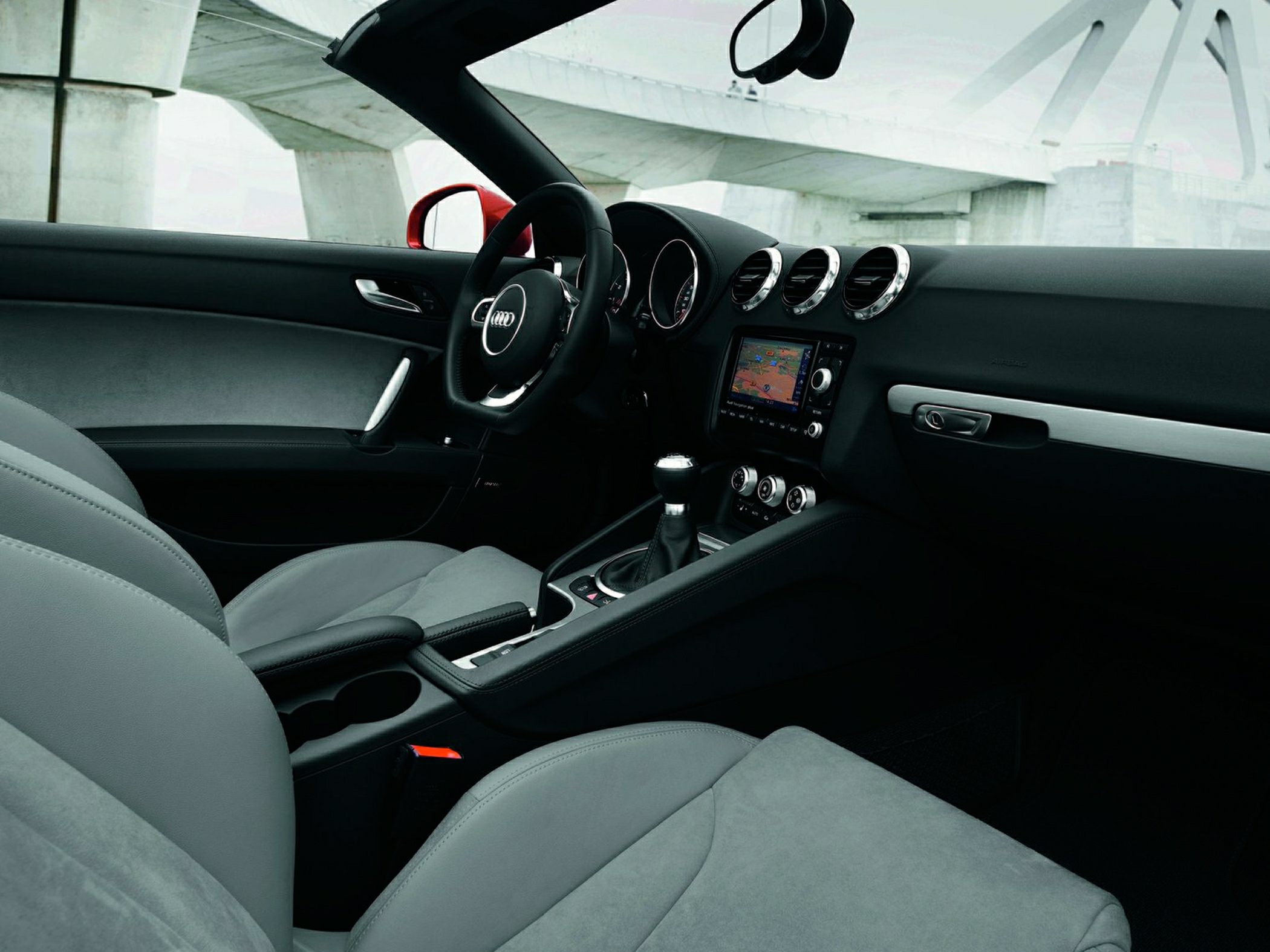 Sporty car interior with dashboard, steering wheel, seats and navigation system