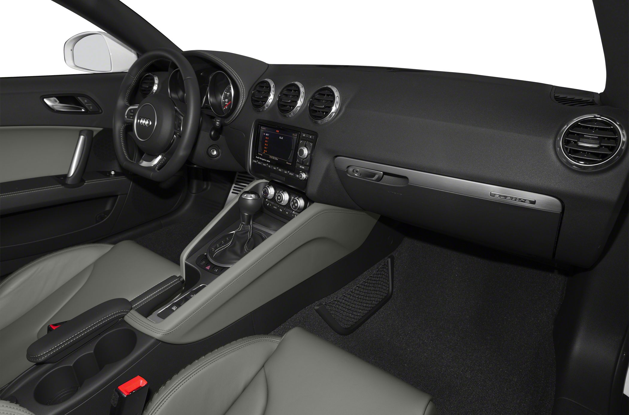 Car interior with dashboard, steering wheel, center console, and air vents