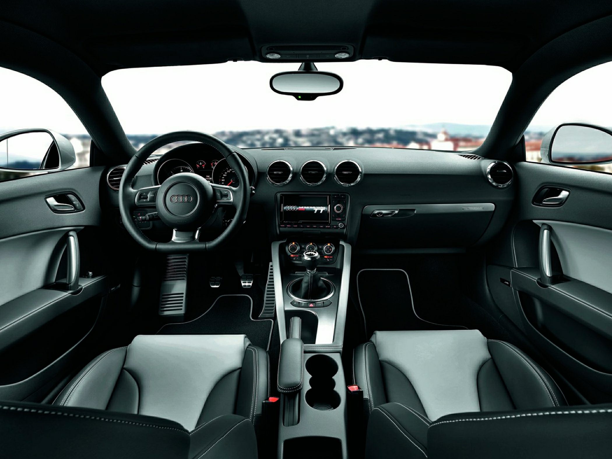 Dashboard, steering wheel, center console, and two-tone leather seats interior