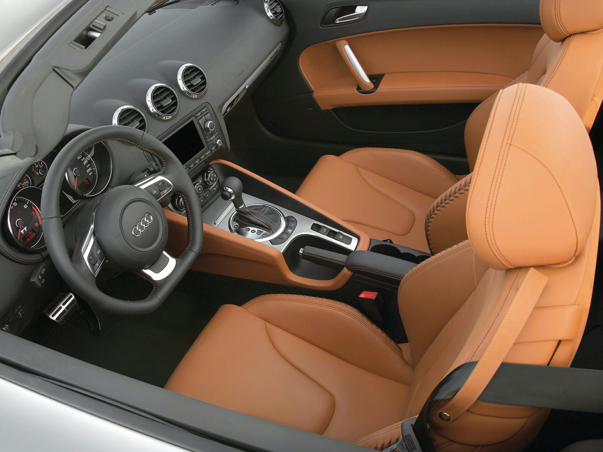 Tan leather sports seats and dashboard with steering wheel and center console