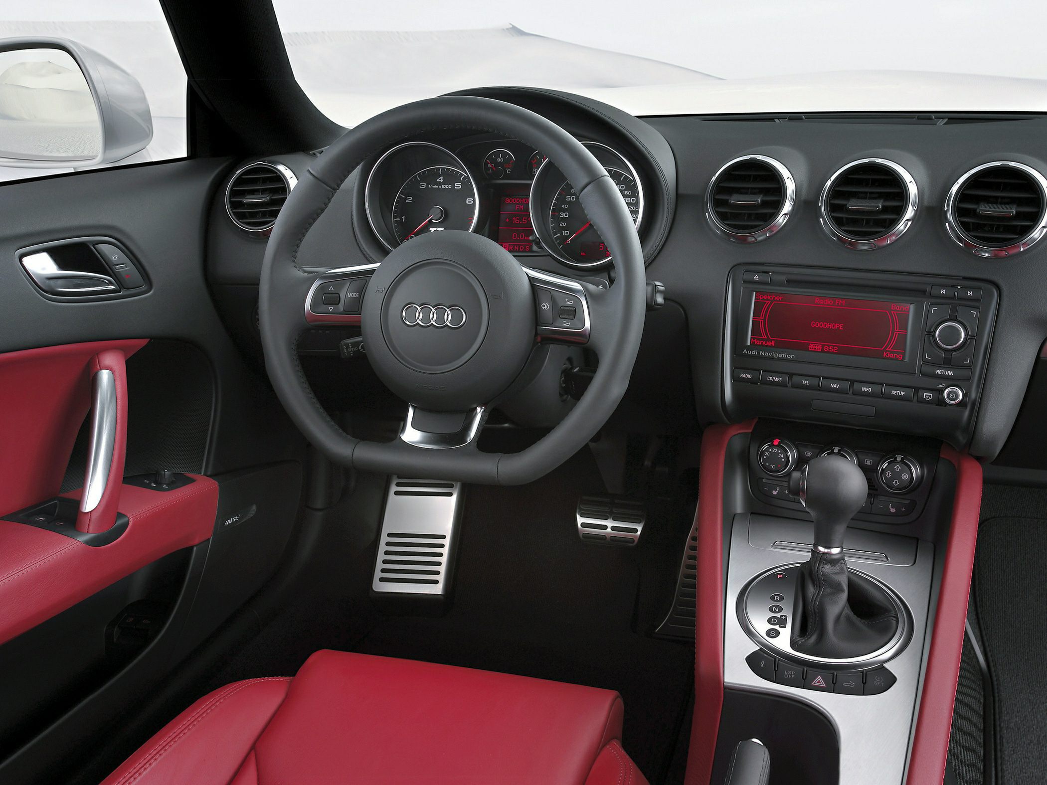 Sporty car interior with red leather seats and advanced dashboard