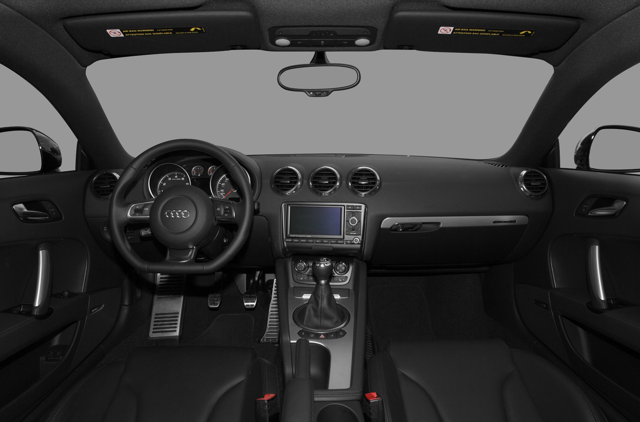 Dashboard, steering wheel, manual gear shift, and central console interior view