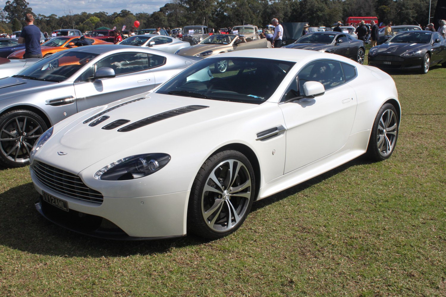 Front three-quarter view of sports coupe with vented hood and sleek side design